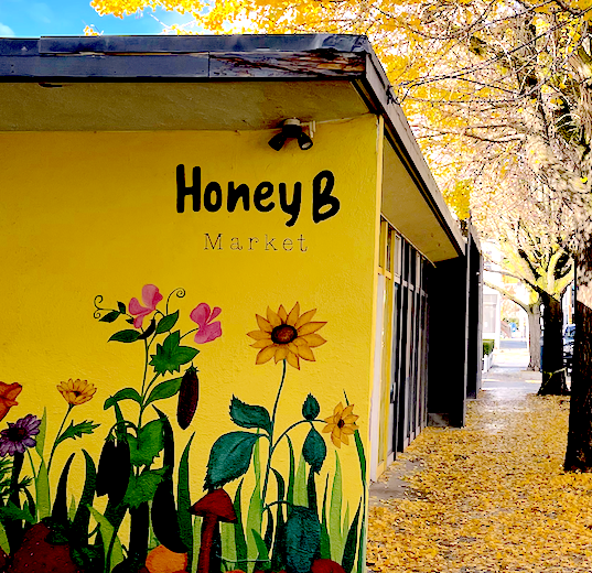 Yellow Honey B Market with floral mural
